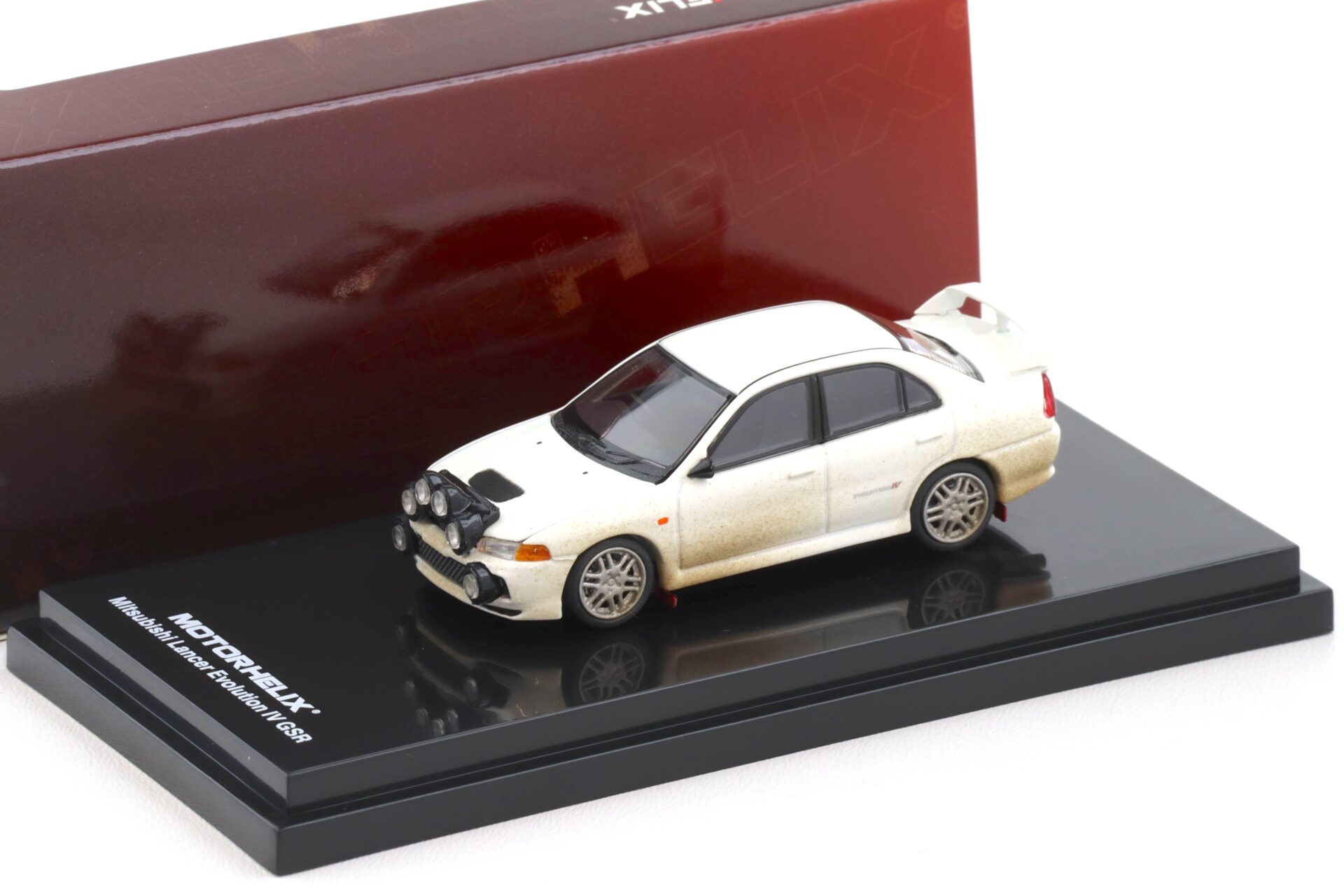1:64 Motorhelix Mitsubishi Lancer Evolution IV GSR Muddy Version with Rally light