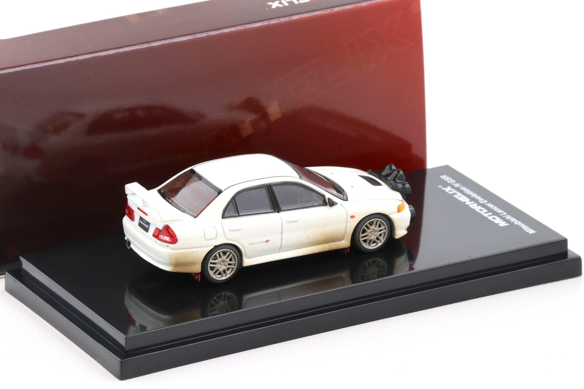 1:64 Motorhelix Mitsubishi Lancer Evolution IV GSR Muddy Version with Rally light