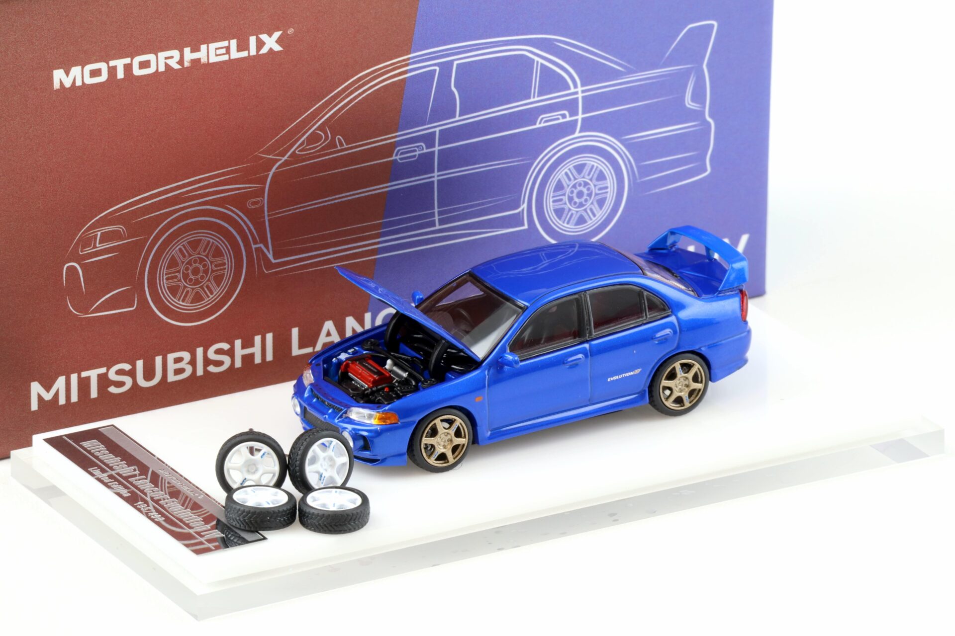 1:64 Motorhelix Mitsubishi Lancer Evolution IV Metal blue + wheels HEC EXPO
